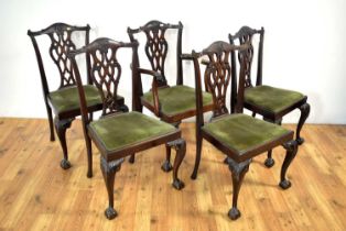 An early 20th Century mahogany extending dining table; and five Chippendale style dining chairs
