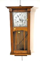 An early 20th Century oak 8-day wall clock