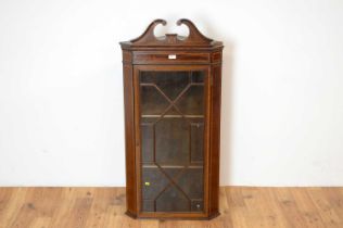 An Edwardian mahogany and satinwood banded corner cabinet