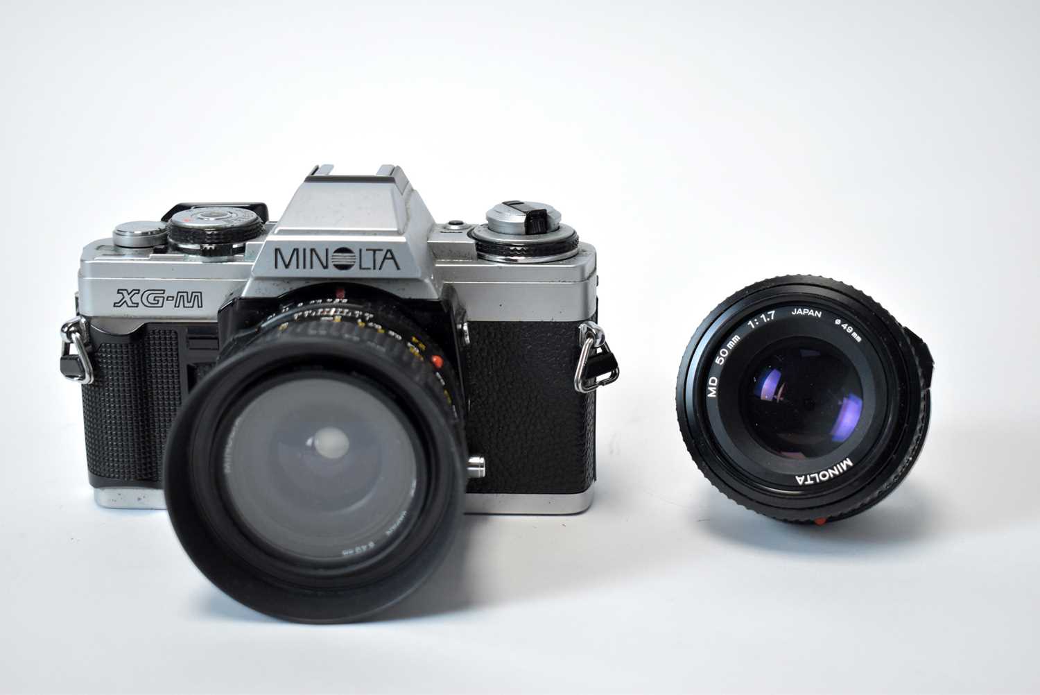 A Minalta XG-M camera and two lenses