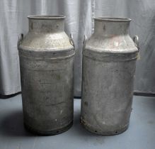 A pair of vintage aluminium milk churns