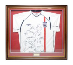 A replica Umbro 2002 England shirt bearing the signature of the England squad