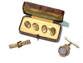 A Victorian yellow metal bar brooch and a pair of cufflinks