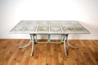 A contemporary cast metal garden table and chairs