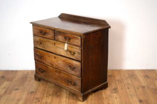 A Georgian mahogany chest of drawers with later stub gallery back