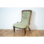 A Victorian walnut framed nursing chair