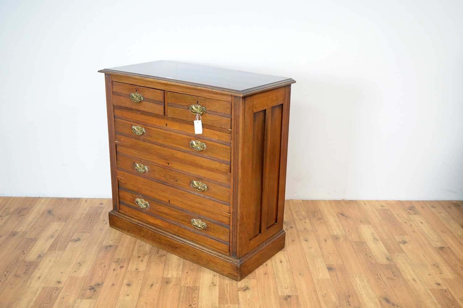 An Edwardian walnut chest of drawers