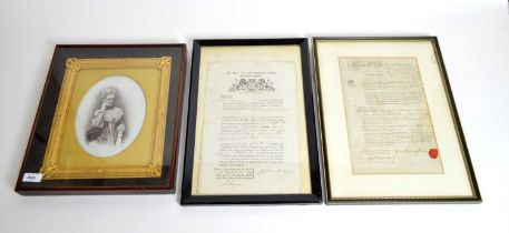 Two framed legal documents, and a framed hand-coloured photograph.