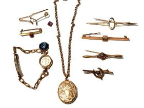 A gold watch, brooches; and an oval pendant