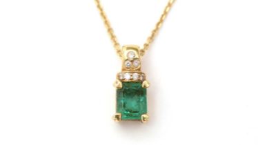 An emerald and diamond pendant on chain