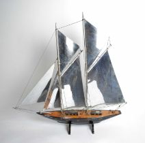 A stained wood model sailing boat