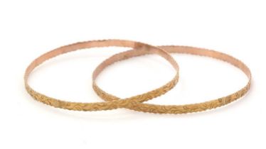 A pair of yellow gold bangles