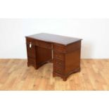 A reproduction mahogany pedestal desk