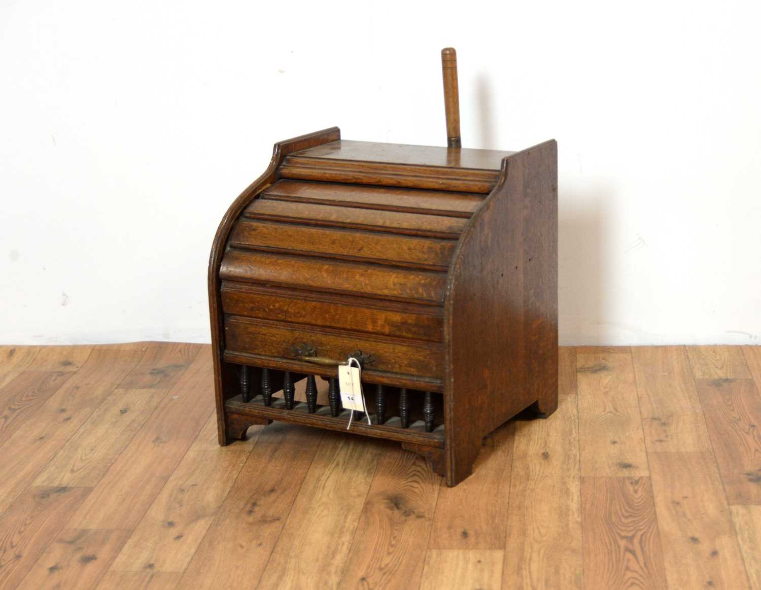 An Edwardian tambour roll oak coal box