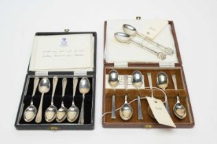 Two silver golfing spoons; and two cased sets of teaspoons
