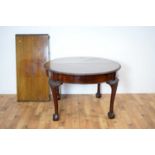 A 1920s mahogany extending dining table