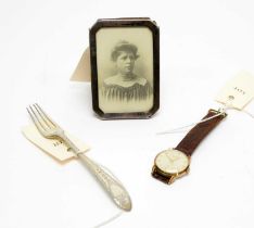 An Ingersoll wristwatch; a silver photograph frame; and a silver fork