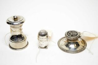 An Edwardian silver inkwell; a pepper grinder; and a pepper shaker