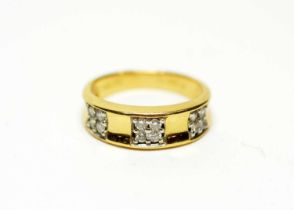 A diamond and yellow gold half-hoop ring
