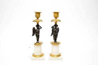 A pair of French Neoclassical gilded bronze candlesticks
