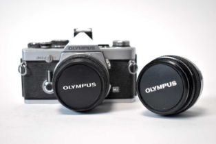 An Olympus OM-2N camera and lenses