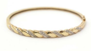 A diamond and 9ct yellow gold bangle