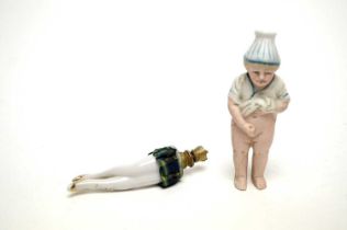 A 19th century German novelty figure of 'Pee Willy', with a novelty scent bottle