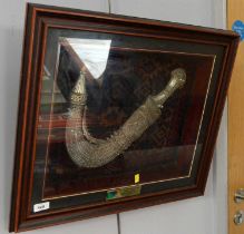 An Arab Jambiya dagger in display case, and others