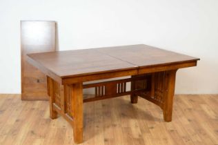 A 20th Century oak extending dining table and chairs