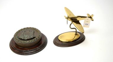 A cast bronze ships tampion and a lacquered brass Spitfire