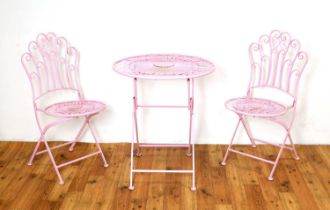 A collection of contemporary metal furniture painted in a vibrant pink colourway