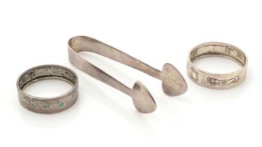 A pair of Edwardian silver “CYMRIC” sugar tongs; and two napkin rings