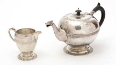 A George V silver teapot and matching milk jug