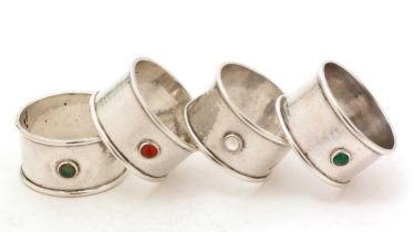 A set of four George V hand-made silver napkin rings
