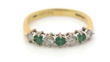 An emerald and diamond ring