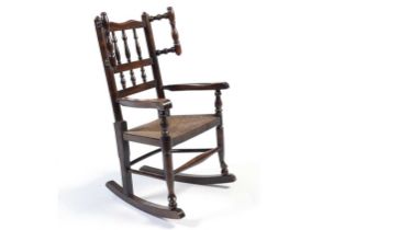 A 19th Century oak spindle back child’s rocking chair