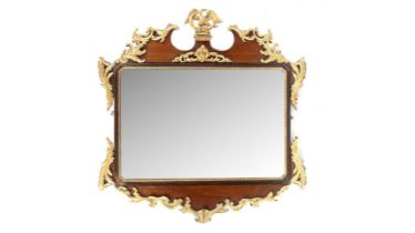 An ornate late 19th Century giltwood and mahogany wall mirror
