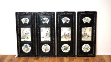 A set of four Chinese oriental decorative ebonised hardwood and porcelain panels