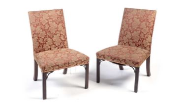 A pair of Georgian mahogany hall chairs in the Chippendale style