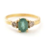 An emerald and diamond ring