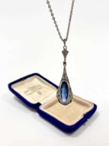 An Art Deco white metal and blue paste pendant on chain