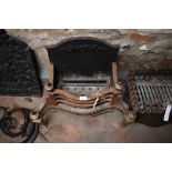 A traditional Adam style brass and cast iron backed fire basket to/w a set of five steel fire irons,