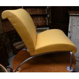 A contemporary yellow fabric (zip cover) tubular alloy framed easy chair