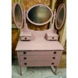 A pink painted mirror backed three drawer dressing chest, raised on square tapering legs, on ceramic