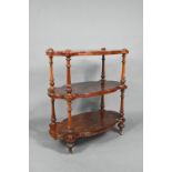 A Victorian figured walnut three-tier whatnot, of all-round serpentine form, raised on brass