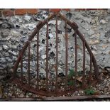 A vintage cast iron corner hay rack