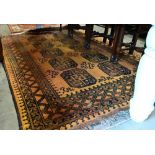 A Golden Afghan rug, repeating gul design within dark repeating borders and kelim ends, 216 x 157 cm