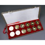 A boxed set of twelve Chinese Zodiac gilt coins in proof-cases, each 32mm diam