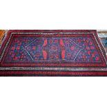 A Persian Baluch rug, scattered rosettes on blue ground and guarded rosette border in cream, 200 x