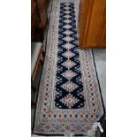 Indo-Persian Turkoman design runner with diamond medallions on a navy blue field framed by the